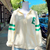 A beige and green striped cardigan with the letter 'E' on the front and 'Go Birds' on the back, displayed on a mannequin outdoors.