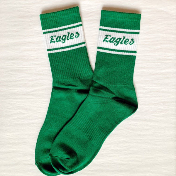 A pair of green Philadelphia Eagles classic sports socks with white stripes and the word 'Eagles' printed on the cuffs.