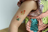 Temporary floral tattoos on a child's arm.