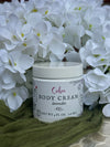 Jar of body cream labeled 'Calm' with lavender scent, surrounded by white flowers.