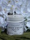 Jar of unscented body cream with white flowers in the background