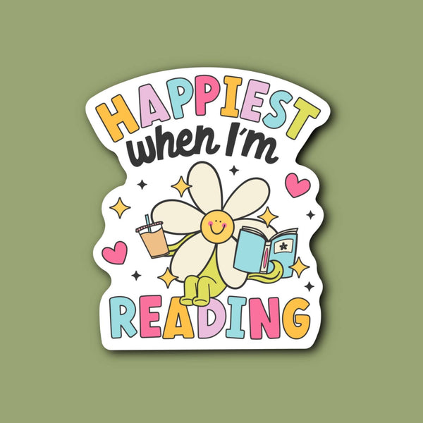 Sticker with a cartoon flower holding a book and text 'Happiest when I'm Reading' on a green background