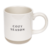 A white stoneware coffee mug with 'COZY SEASON' text in black on both sides.