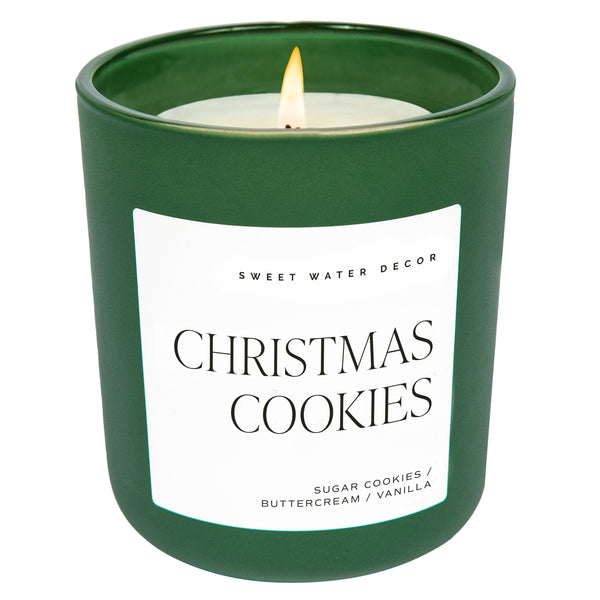 A green matte jar candle labeled 'Christmas Cookies' with white text, from the brand Sweet Water Decor.
