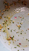 Close-up of a plate with food remnants and a small pink face emoji.