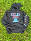 Black hoodie with 'PHILLY' and Liberty Bell design on grass
