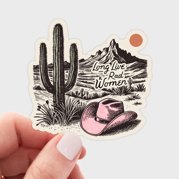 Sticker with a cactus, pink cowboy hat, and mountain landscape with 'Long Live Rad Women' text, held by a hand.