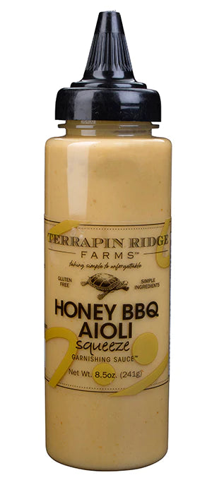 A bottle of Terrapin Ridge Farm Honey BBQ Aioli sauce with a black cap and label that includes the product name and brand.