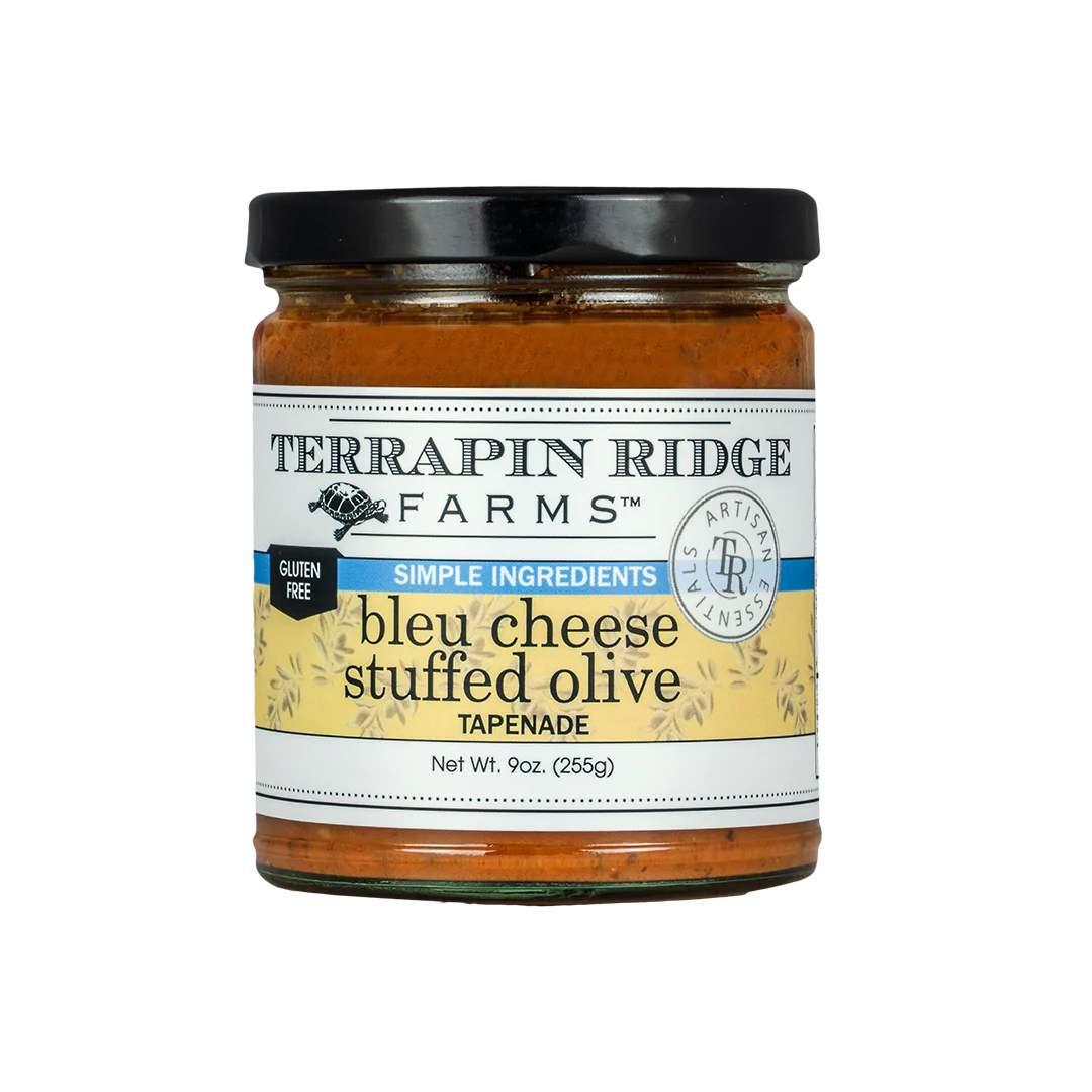 A jar of Terrapin Ridge Farms Blue Cheese Stuffed Olive Tapenade, with a label showing the product name and a brief description.