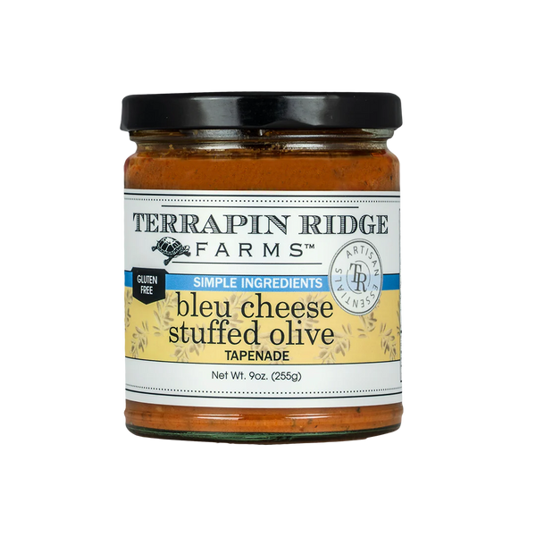 A jar of Terrapin Ridge Farms Blue Cheese Stuffed Olive Tapenade, with a label showing the product name and a brief description.