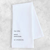 White napkin with black text on a light gray background