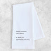 White towel with black text on a light gray background