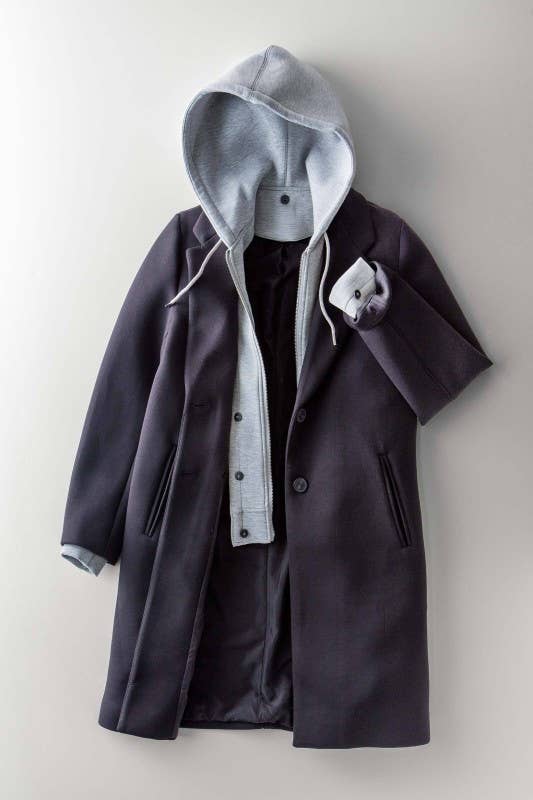 Dark coat with gray hood on a light background