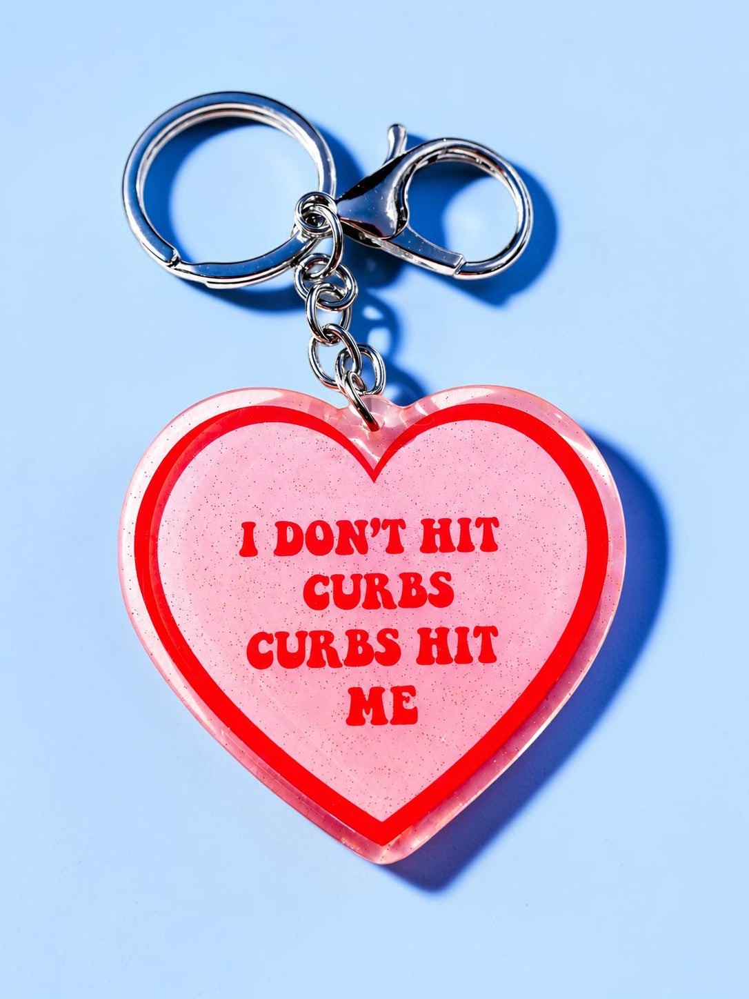 I DON'T HIT CURBS, CURBS HIT ME HOLOGRAPHIC HEART KEYCHAIN