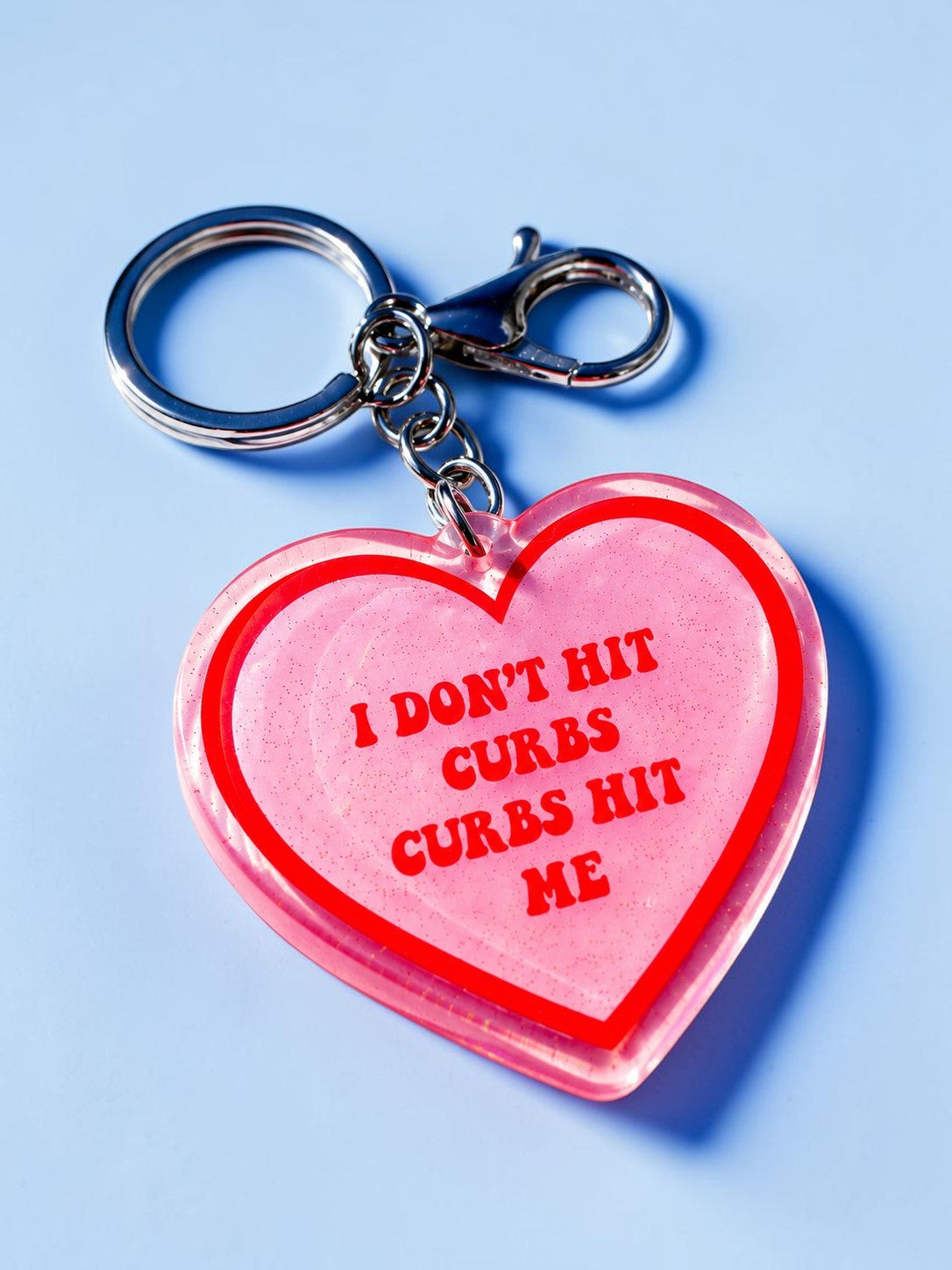 I DON'T HIT CURBS, CURBS HIT ME HOLOGRAPHIC HEART KEYCHAIN