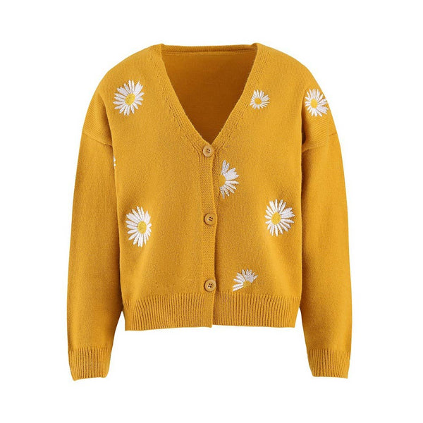 Yellow cardigan with white floral patterns on a white background