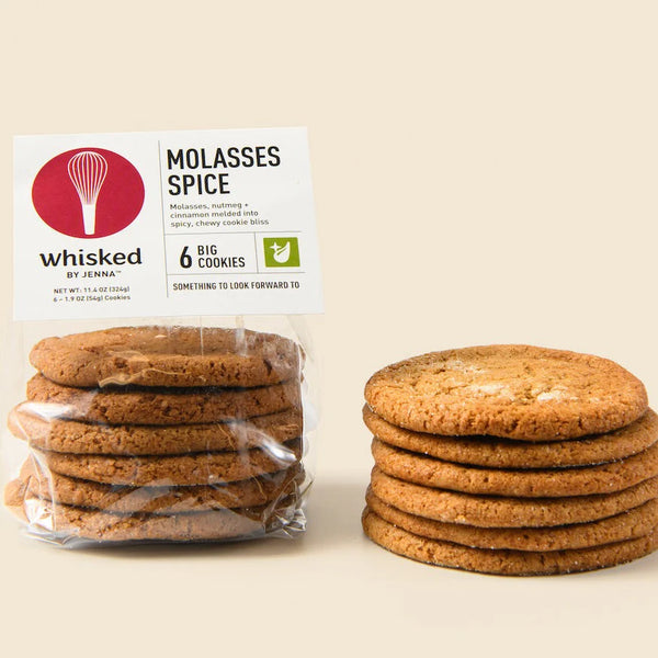 Packaged cookies with a Whisked by Jenna label on a beige background