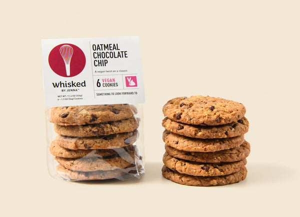 Packaged cookies with a stack of cookies on a beige background
