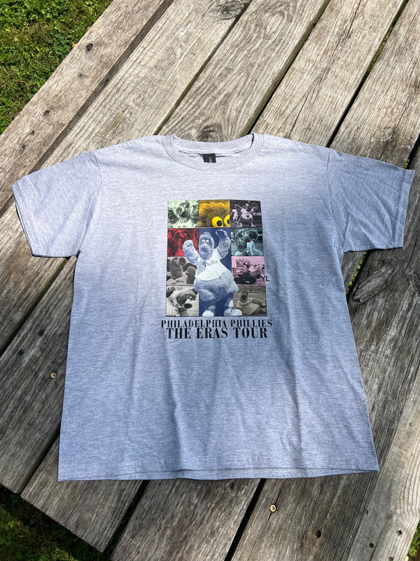 Gray t-shirt with a graphic design on a wooden surface