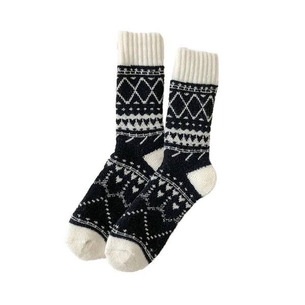 Pair of black and white patterned socks on a white background
