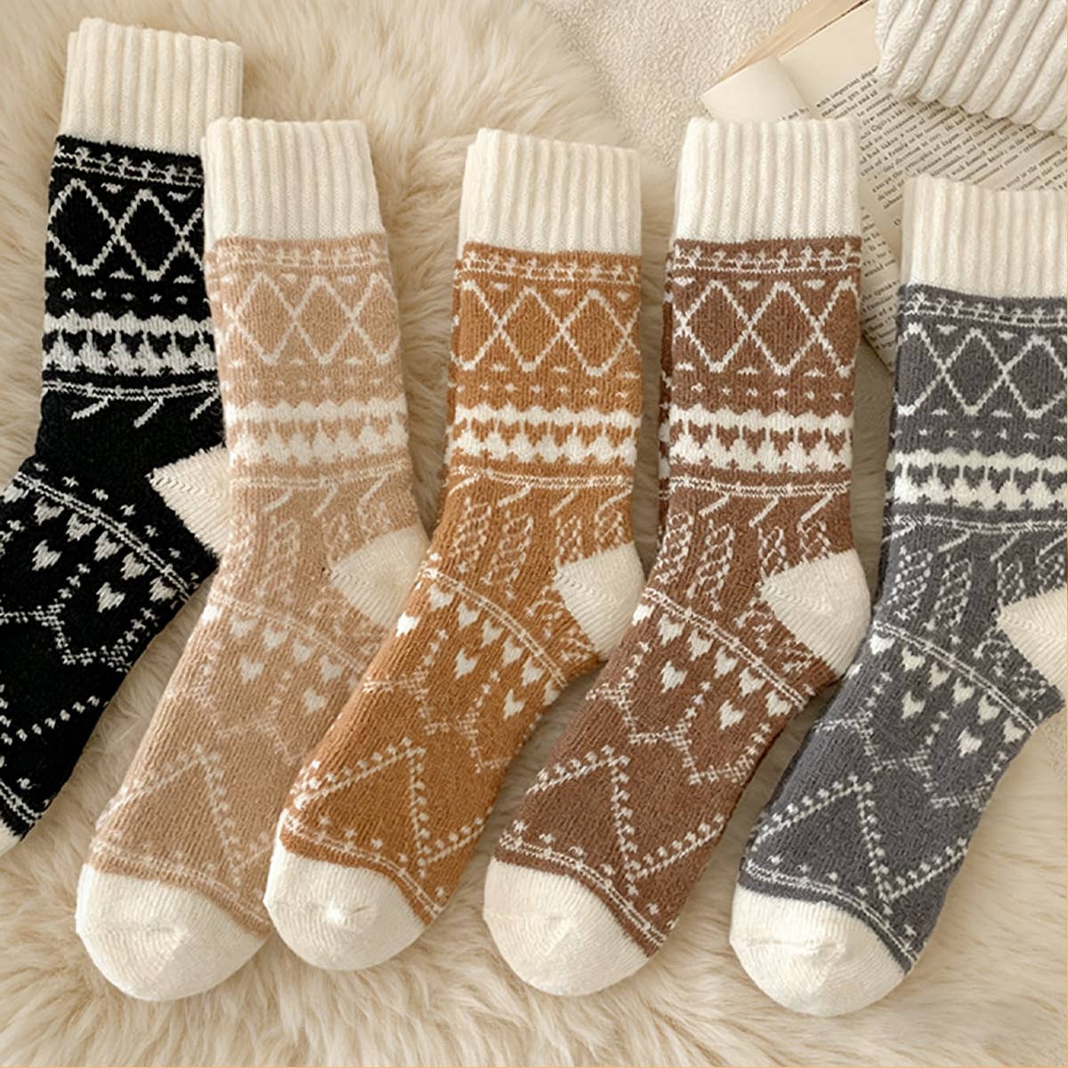 Set of patterned socks on a soft fabric background