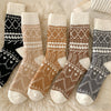 Set of patterned socks on a soft fabric background