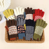 Assorted colorful gloves with patterns arranged in a basket on a light background