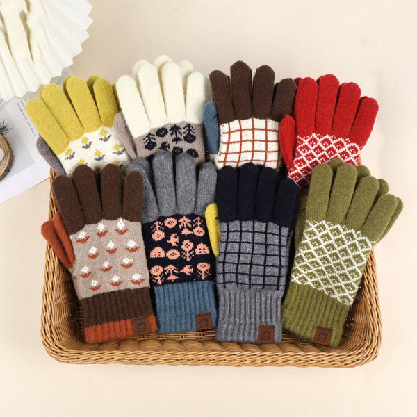 Assorted colorful gloves with patterns arranged in a basket on a light background