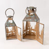 Two decorative metal lanterns with a forest and deer cutout design, shown on a plain light background. One lantern is closed and the other is open, displaying the interior and side doors.