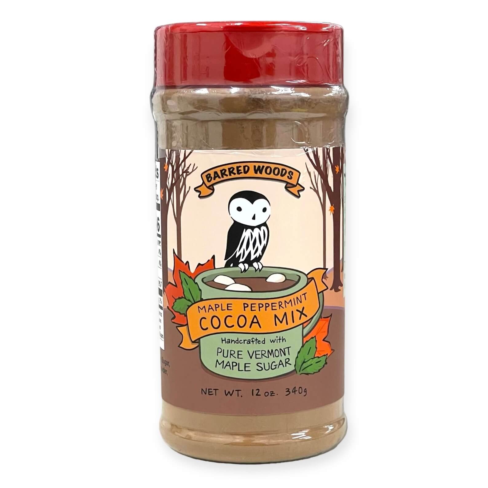 A 12 oz jar of Barred Woods Maple Peppermint Cocoa Mix, featuring a red lid and a label with an owl and autumn leaves, set against a plain white background.