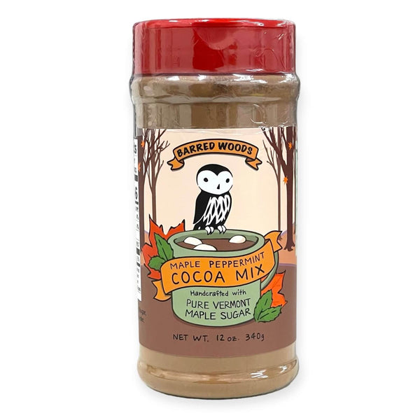 A 12 oz jar of Barred Woods Maple Peppermint Cocoa Mix, featuring a red lid and a label with an owl and autumn leaves, set against a plain white background.
