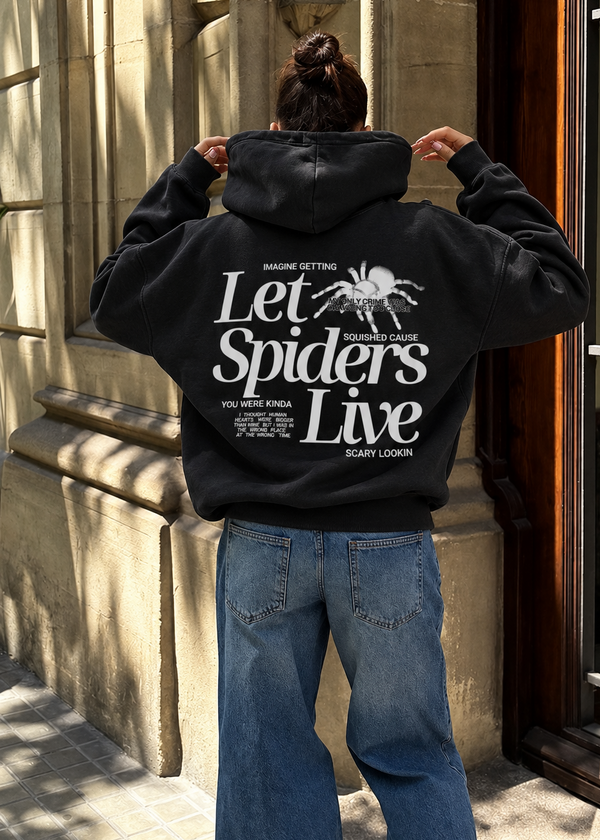 black sweatshirt on model showing back design in white that says let spiders live with graphic of a spider
