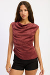 Woman wearing a burgundy sleeveless top and black shorts on a white background