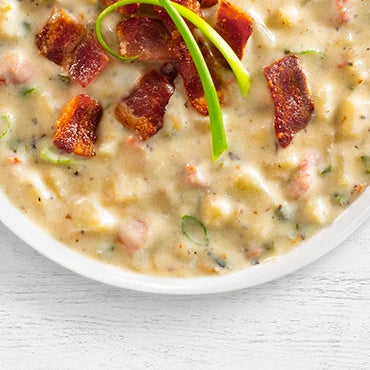 Bowl of potato soup with bacon chunks