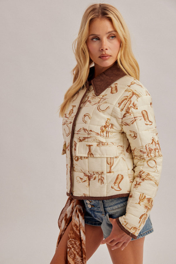 A blonde model wearing a cream-colored quilted jacket with a brown western-themed print and a brown faux-shearling collar, styled with denim shorts and a matching brown scarf against a light gray studio background.