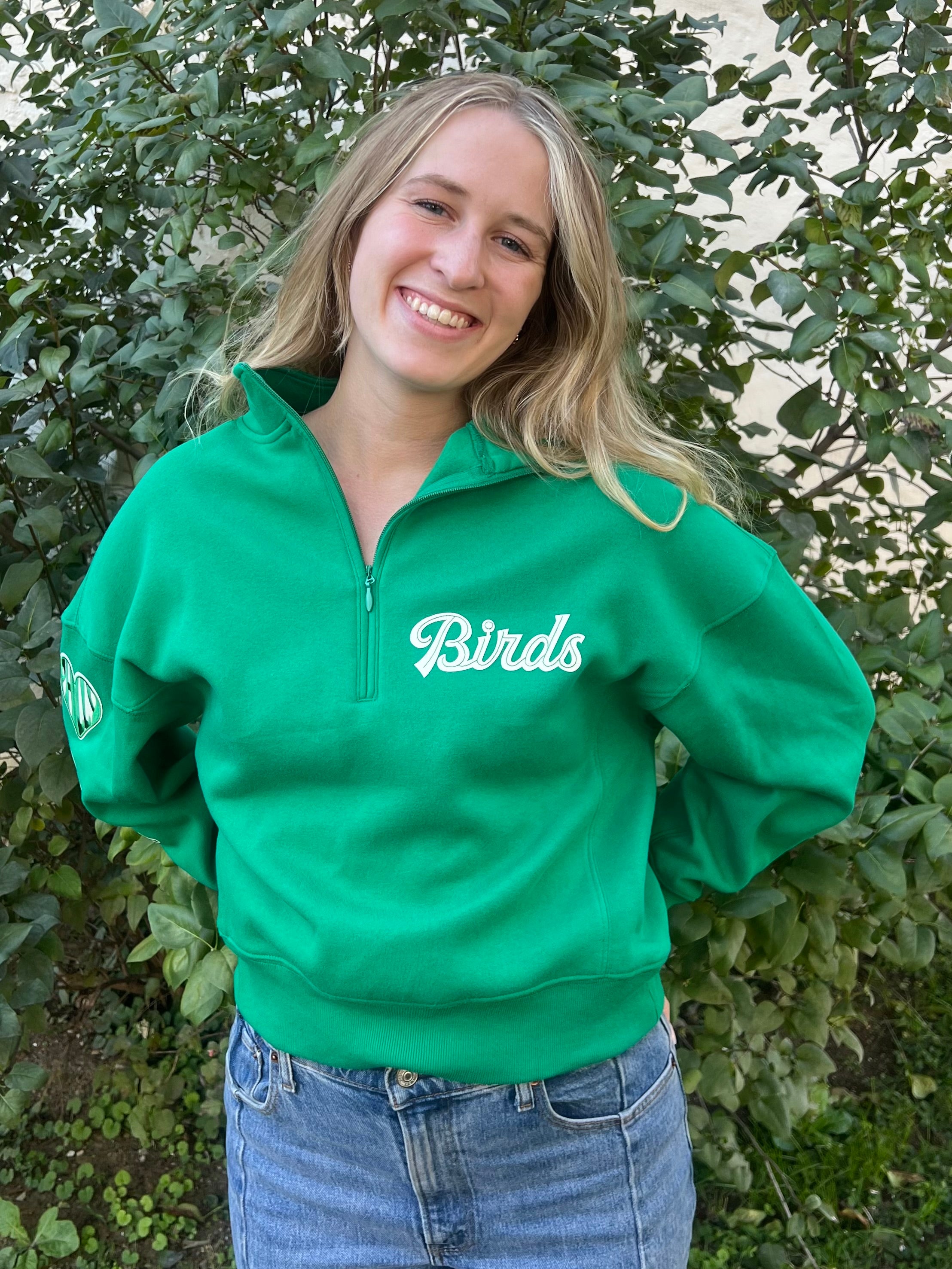 woman model wearing a green birds quarter zip