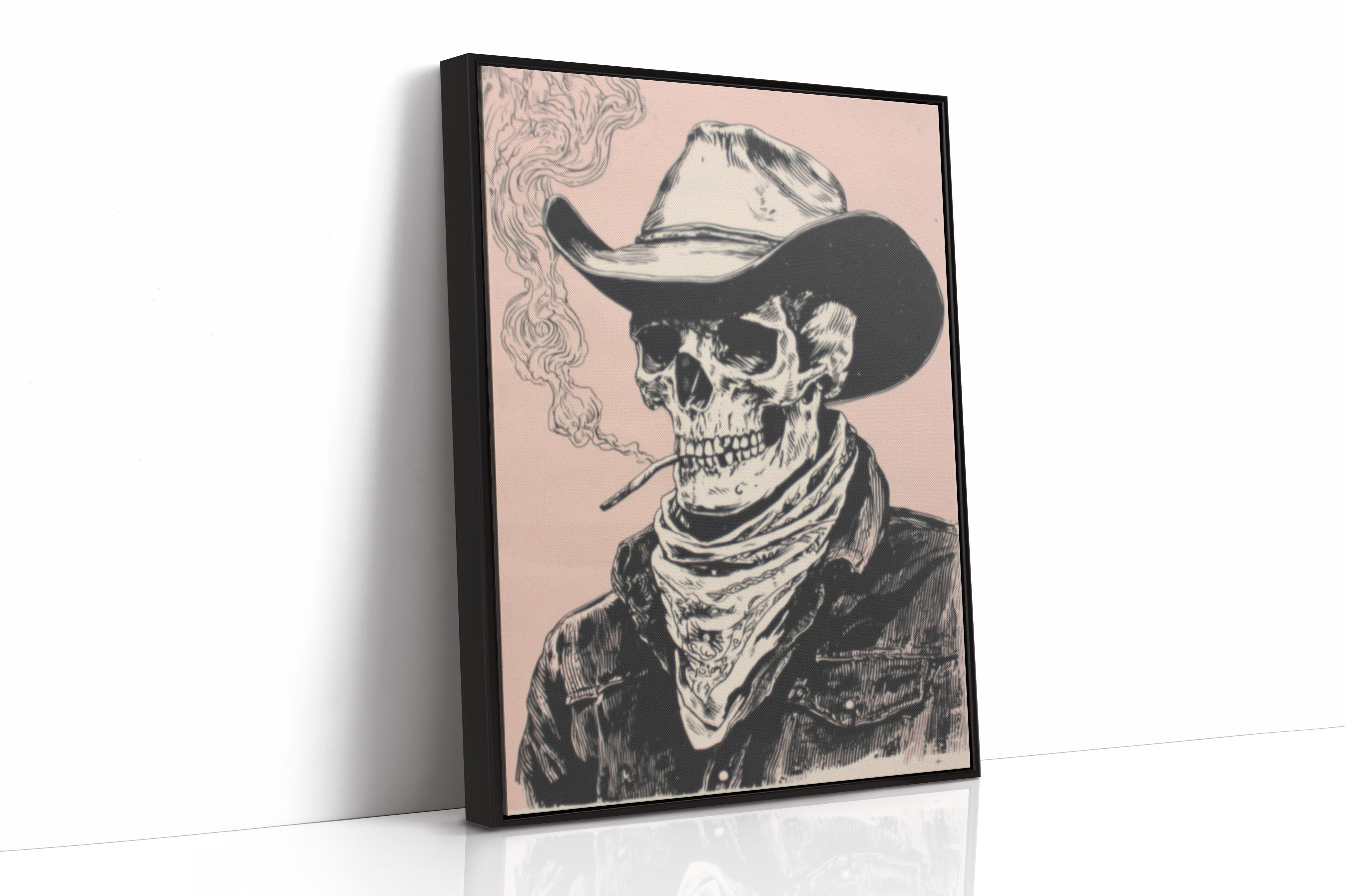 A framed art print featuring a black and white illustrated skeleton wearing a cowboy hat and bandana, smoking a cigarette against a pale pink background. The print is shown standing upright at a slight angle on a white surface with a clean white wall behind it.