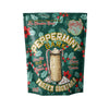 A stand-up pouch of Peppermint Bark Frozen Cocktails on a plain white background. The packaging is dark green with a festive holly and berry pattern, featuring an illustration of a decorated mug and gold text.