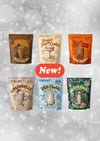 Six stand-up pouches of frozen cocktails in assorted flavors are arranged on a sparkly gray background with a red 'New!' badge in the center. The flavors shown are Peanut Butter, Floured Sugar Cookie, Maple Brown, Gingerbread, White Chocolate Strawberry, and Peppermint.
