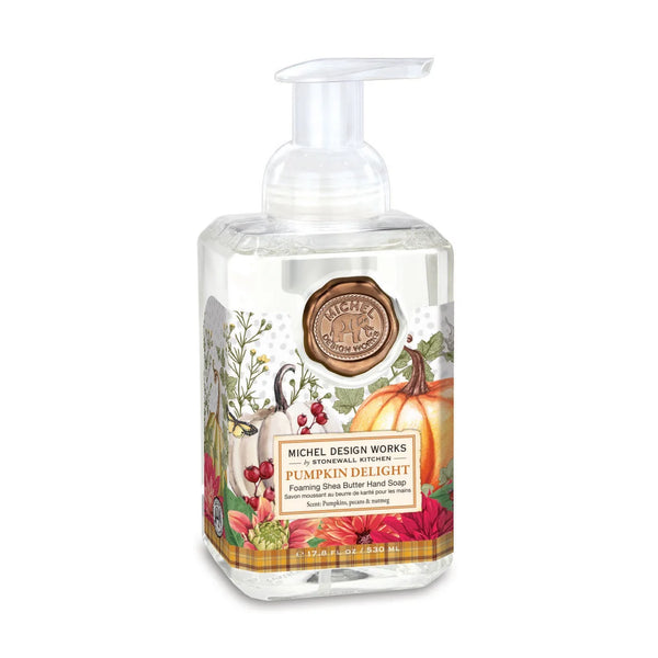Michel Design Works 'Pumpkin Delight' foaming hand soap in a clear plastic bottle with a white pump dispenser, featuring a colorful autumn-themed label with pumpkins, leaves, and a goose on a white background.