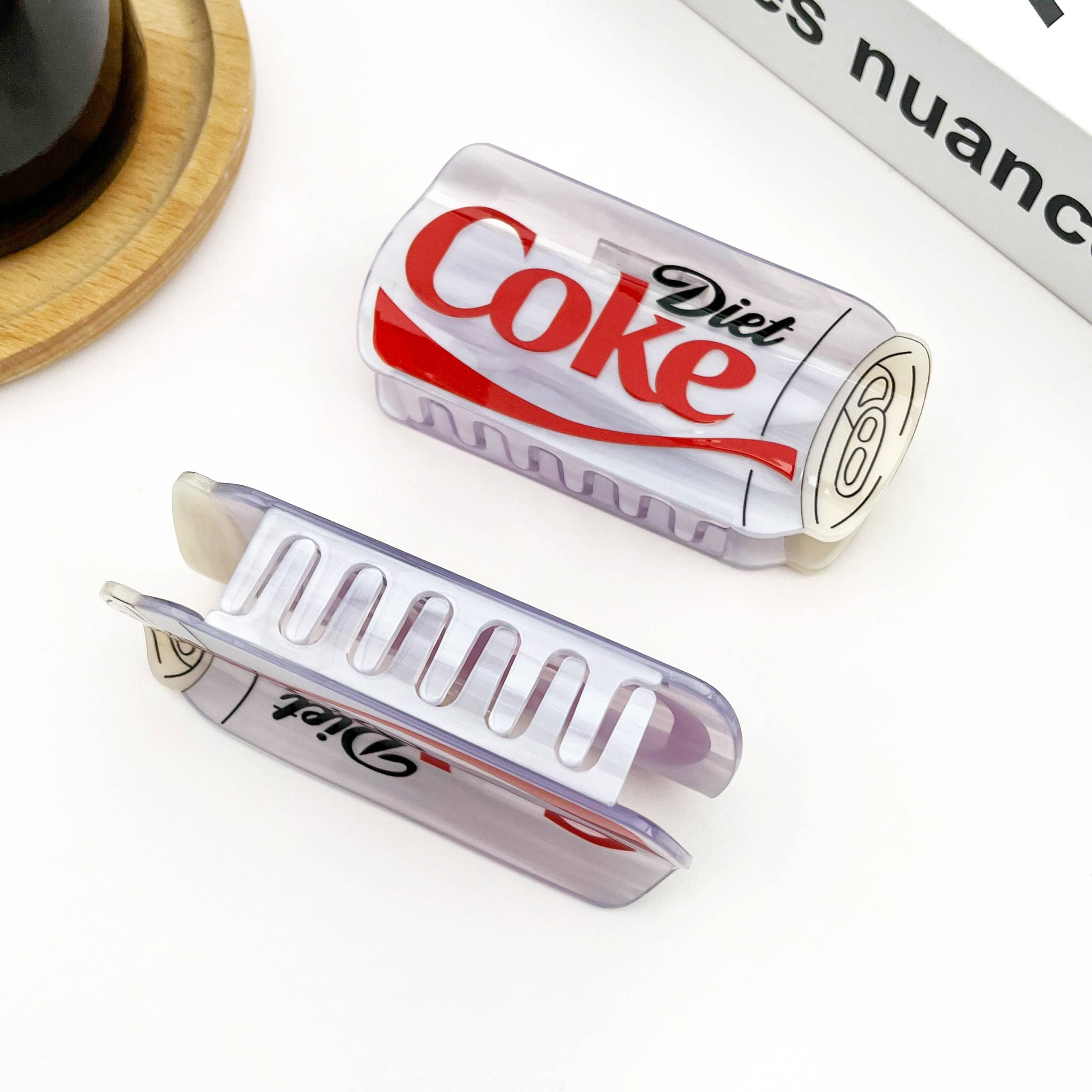 Diet Coke can-shaped hair clip on a white background