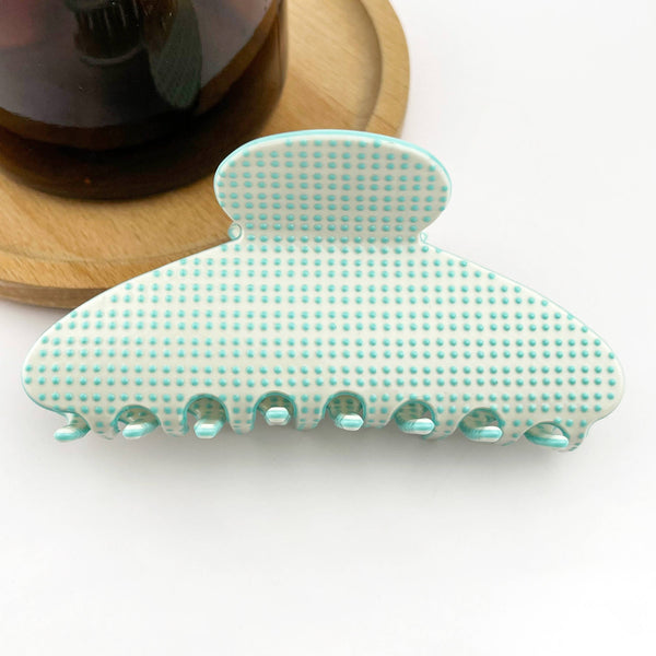 Green and white patterned hair clip on a white background