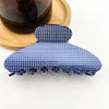 Blue polka dot hair clip on a white background