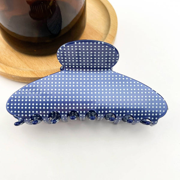 Blue polka dot hair clip on a white background