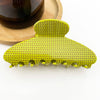 Yellow hair claw clip on a white background