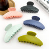 Set of colorful hair clips on a white surface