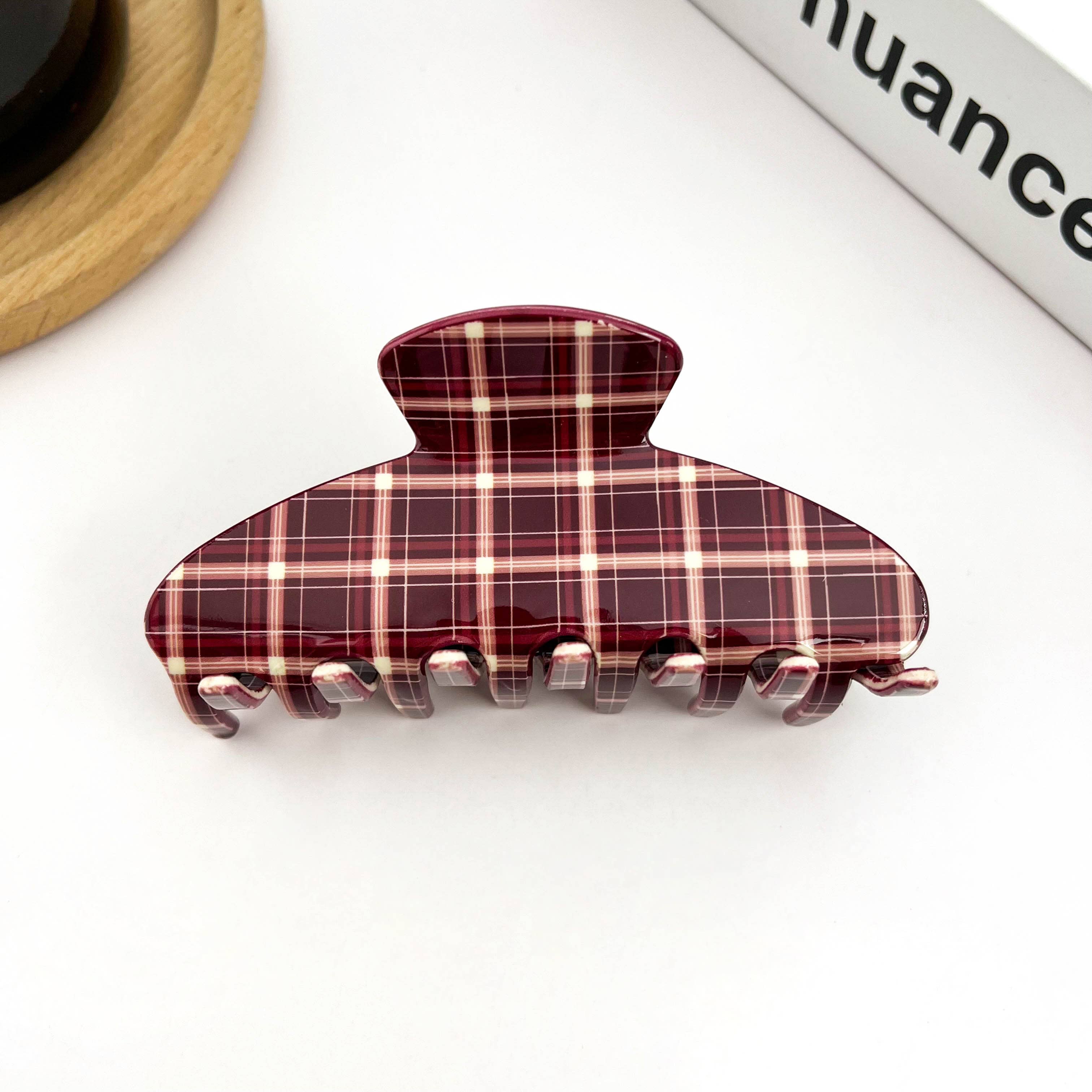Plaid patterned hair clip on a white background
