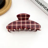 Plaid patterned hair clip on a white background