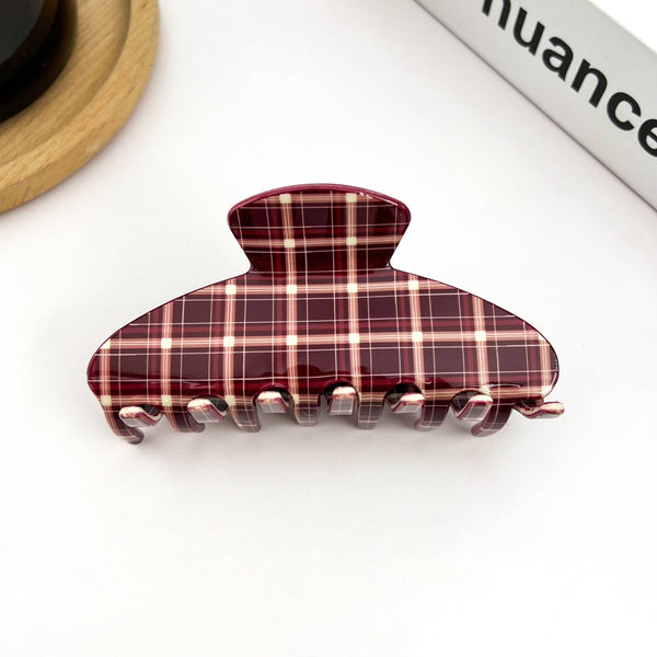Plaid patterned hair clip on a white background