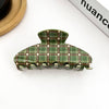 graen and brown claw clip on white background